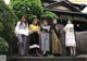 A group of young women standing in front of a building.