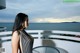 A woman in a black and white dress standing on a balcony.